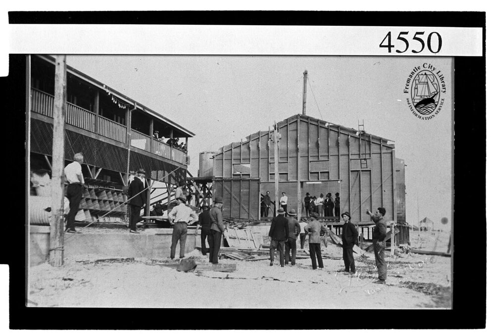 Crew working on demolition of old dressing shed