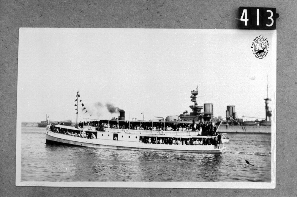 Zephyr (ferry) passing H.M.S. Repulse or Hood, No 1 North Wharf