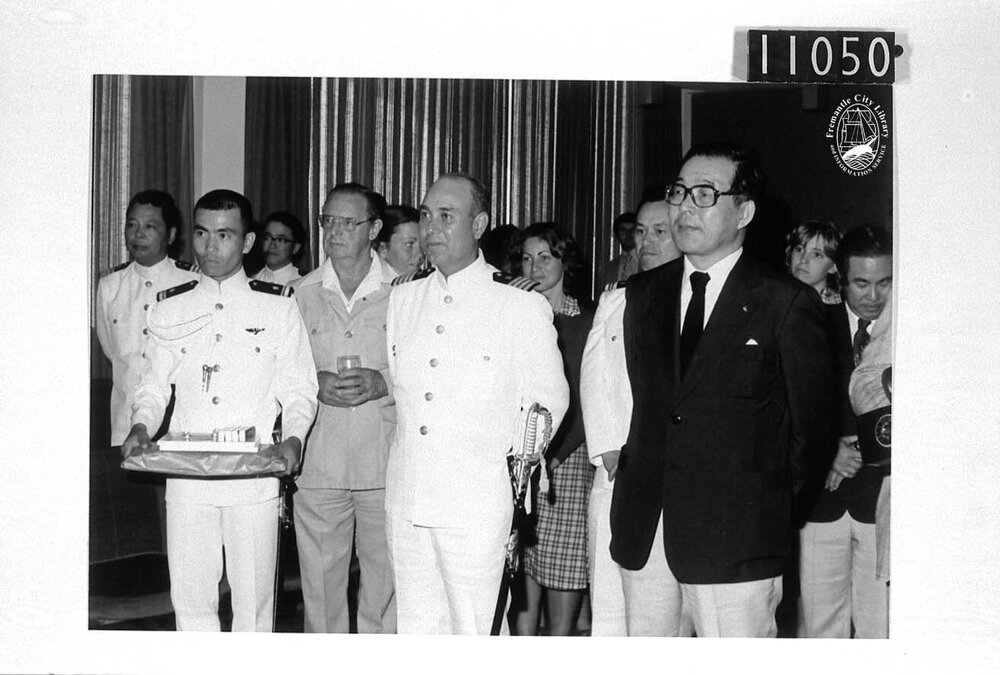 Captain Nei, Professor Kizaki and audience listen to the Mayor