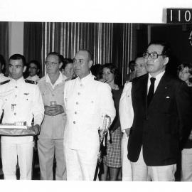 Captain Nei, Professor Kizaki and audience listen to the Mayor