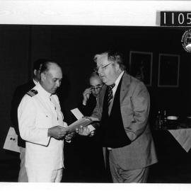 Captain Nei presents documents to the Mayor