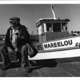 Lou Santaromita sitting beside his fishing boat "Mareelou"at Fishing Boat Harbour