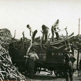Unloading sandalwood from railway wagon