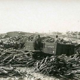 Unloading sandalwood from railway wagon